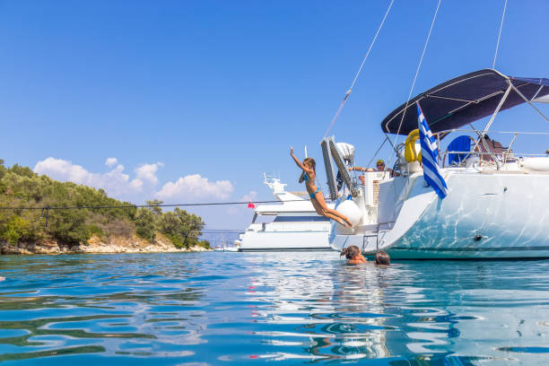 istock Children jumping from the sailboat 682944280