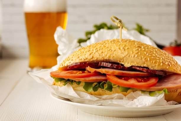 istock Sandwich with ham, sausage and tomato 682944476