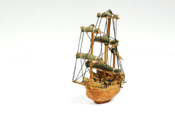 istock Old miniature sailboat made with a nut shell. Isolated on white. 682951378