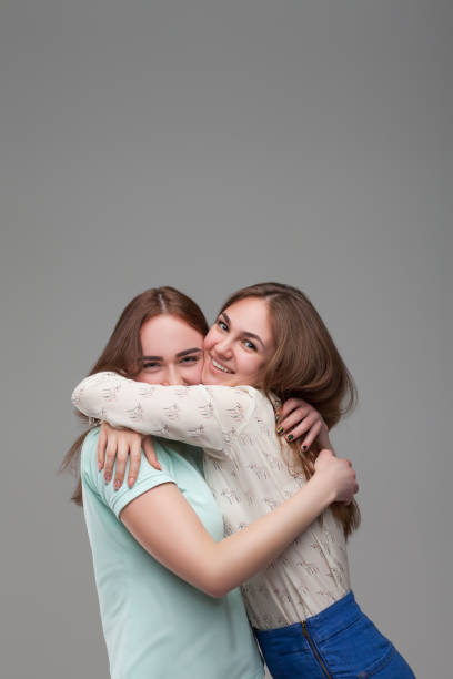istock Two happy girlfriends hugs together 682951438