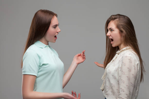 istock Two young women screams at each other 682951532