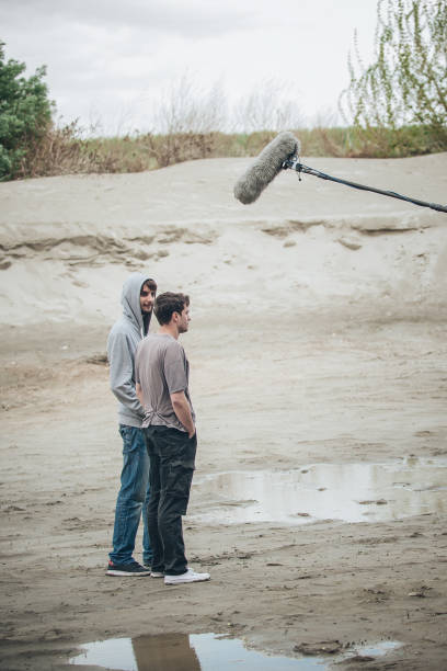 istock Behind the scene. Two actors in front of boom microphone 682954332
