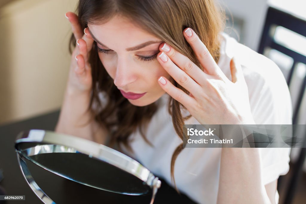 Mujer sentada junto al espejo - Foto de stock de Espejo libre de derechos