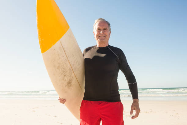istock Low angle view of man carrying surfboard 682964920