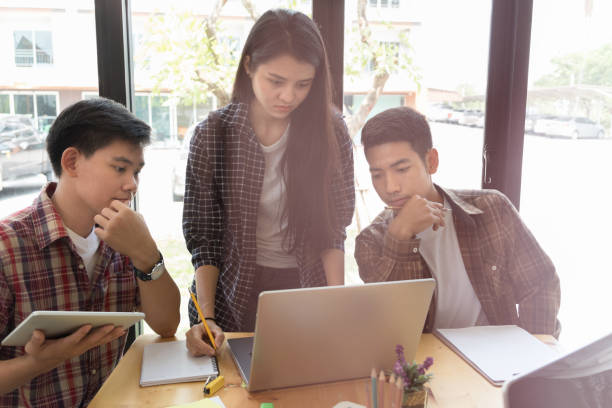 istock young university students studying with computer and tablet in cafe. Group of people in campus library. College teenager using laptop doing group study for school assignment. 682966068