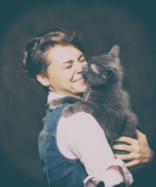 Woman and cat looking at each other.