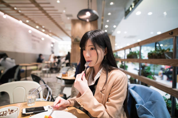 istock Young woman taking coffee break at open cafe 682972942