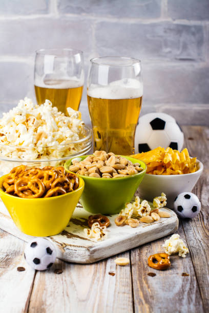 istock Beer and snacks on wooden table 682978686