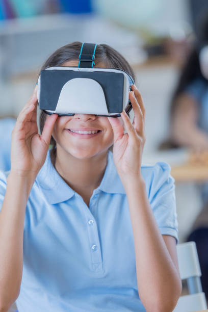 istock Cheerful student uses virtual reality goggles at school 682985540