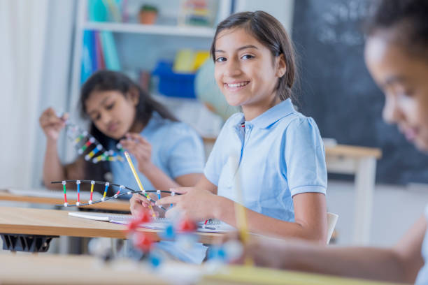 istock Cheerful schoolgirl in science class 682985554