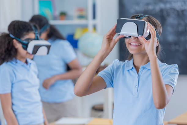 istock Group of students uses virtual reality glasses at school 682985558