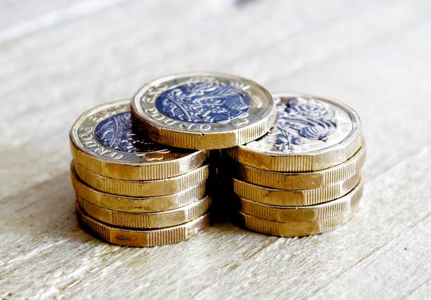 new one pound coin British currency close up