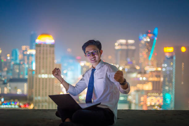 istock Young business man using laptop and digital tablet cityscape background 682993334