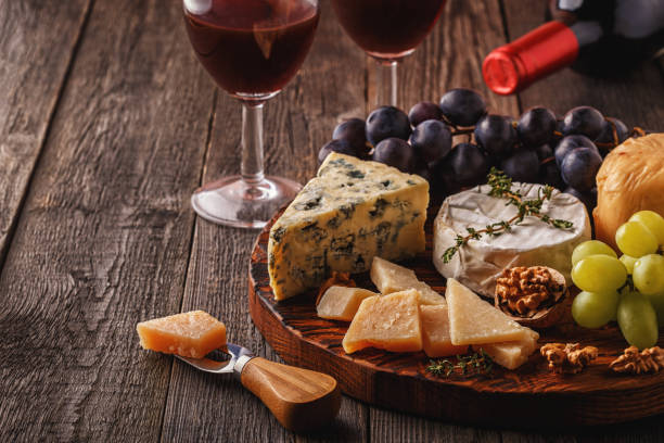 istock Cheese, nuts, grapes and red wine on wooden background 683003748
