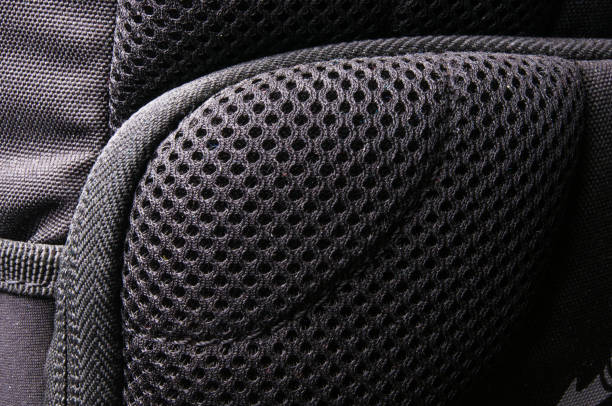 fittings and zips in the backpack closeup of breathable mesh fabric, buckles, clasps, zippers, pockets, fasteners, fittings and seams in the black photo backpack tineola stock pictures, royalty-free photos & images