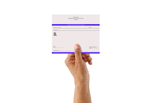 Hand holding blank prescription isolated on white background
