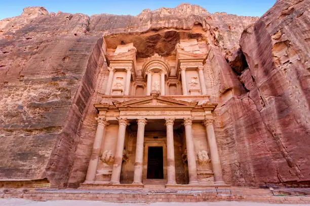 Al-Khazneh ("The Treasury"‎‎) is one of the most elaborate temples in the ancient Arab Nabatean Kingdom city of Petra. As with most of the other buildings in this ancient town, including the Monastery, this structure was carved out of a sandstone rock face.