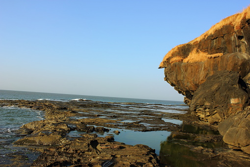 Beach with rocky terrains in Harihareshwar in Maharashtra, India