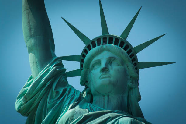 istock Close-up of the Statue of Liberty with a blue background 683024794