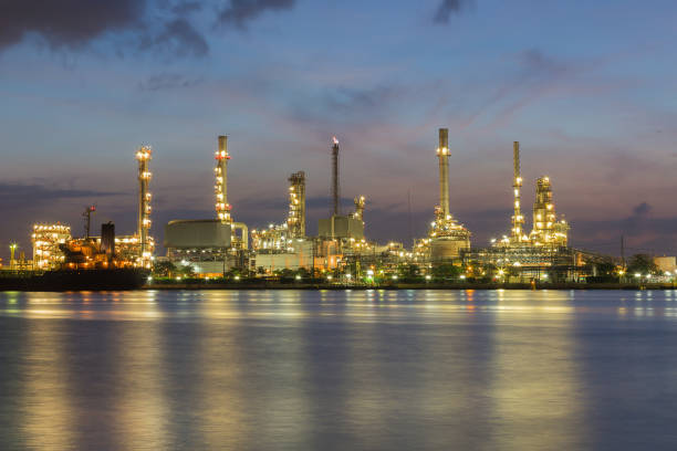 istock Night light Oil refinery river front with twilight skyline 683031670