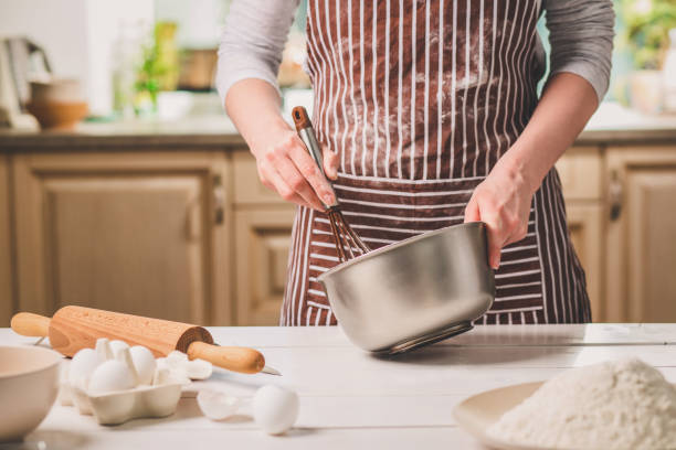 istock Young woman holding bowl with dough and whisk, closeup 683035824