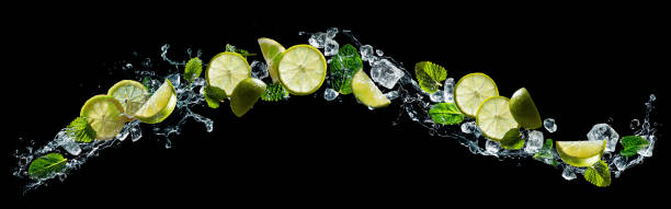 Lime and mint with water splash Lime and lemon pieces with mint and ice in water splash splash screen stock pictures, royalty-free photos & images