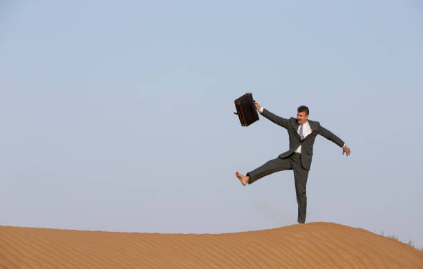 istock man in a suit with a briefcase in a desert 683041206