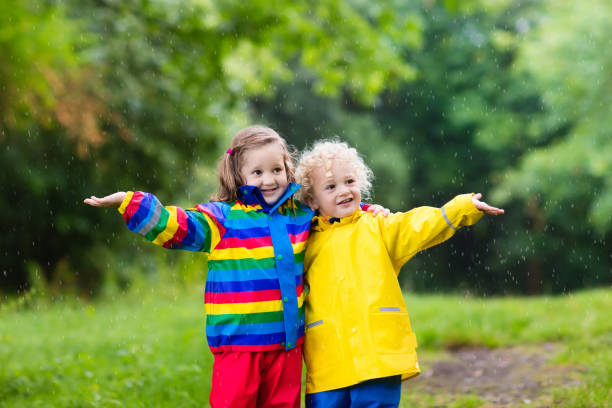 istock Kids play in rain and puddle in autumn 683041338