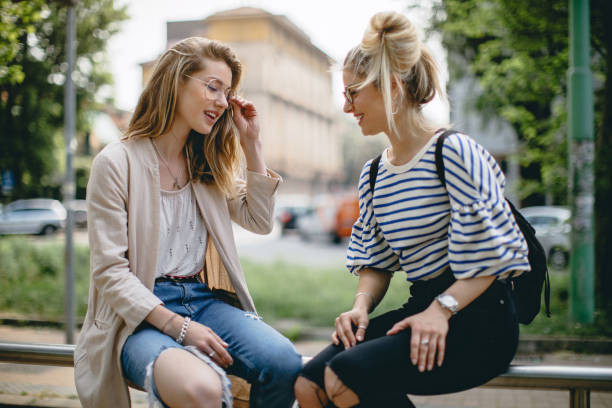 Young women waiting transportation at train station