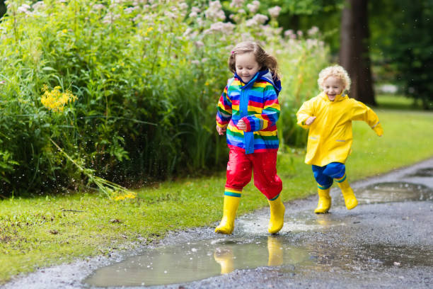 istock Kids play in rain and puddle in autumn 683041766