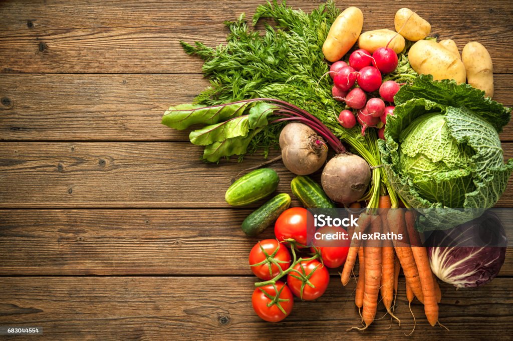 Assortment of the fresh vegetables Assortment of the fresh vegetables on wooden background Vegetable Stock Photo