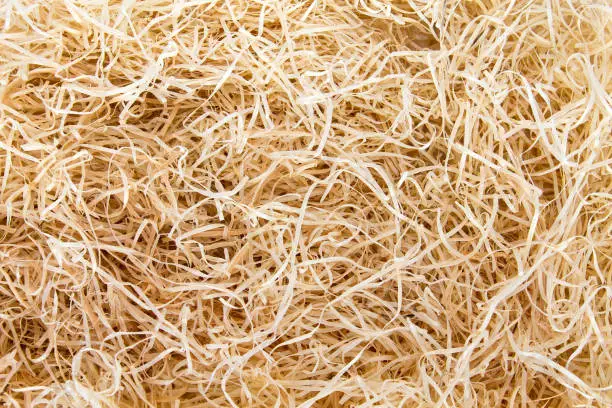 Background of scattered straw. View from above. Hayloft closeup.