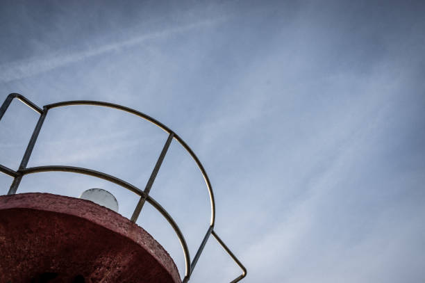 istock Red tower with chrome circular railing against the sky 683051894