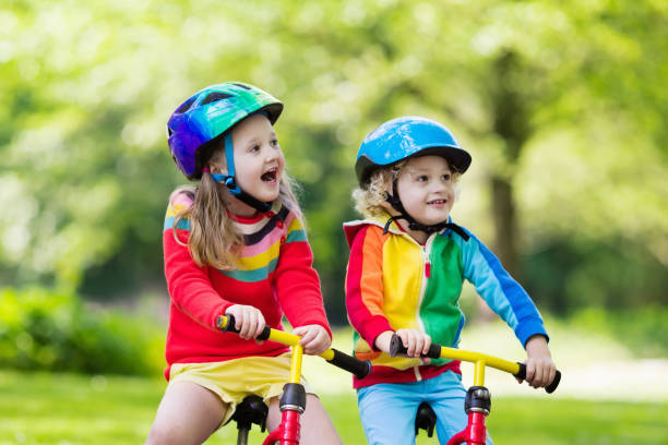istock Kids ride balance bike in park 683053266
