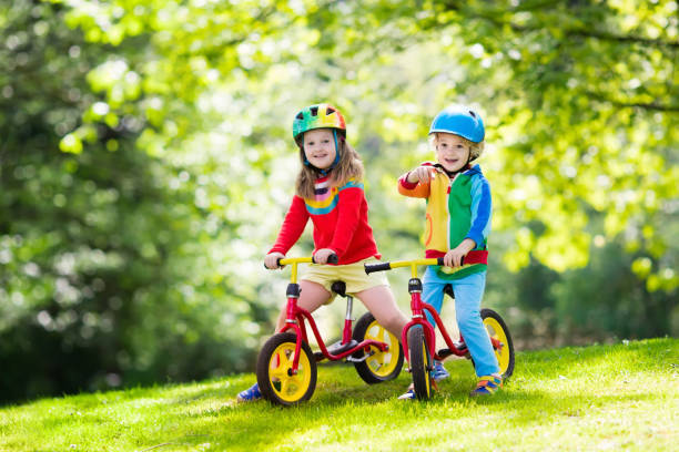 istock Kids ride balance bike in park 683054108