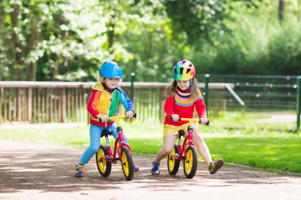 istock Kids ride balance bike in park 683054256