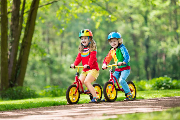 istock Kids ride balance bike in park 683054696