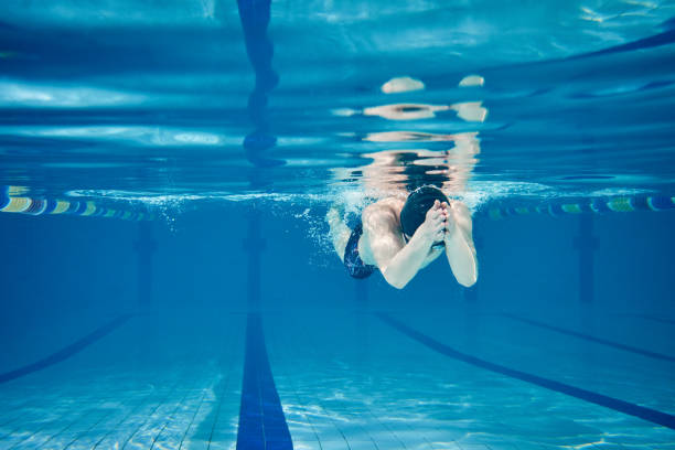 istock Male swimmer swimming underwater in a pool 683054702