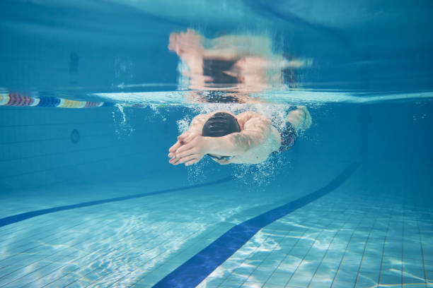 istock Male swimmer swimming underwater in a pool 683054724