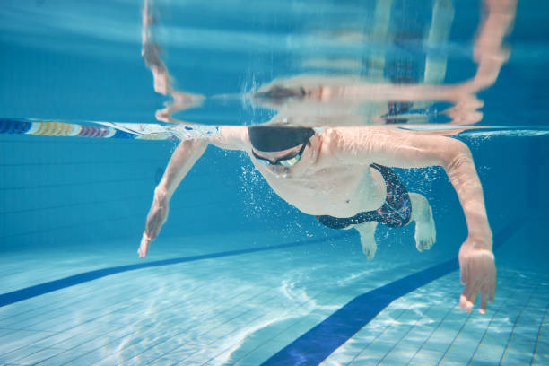istock Male swimmer swimming underwater in a pool 683054728