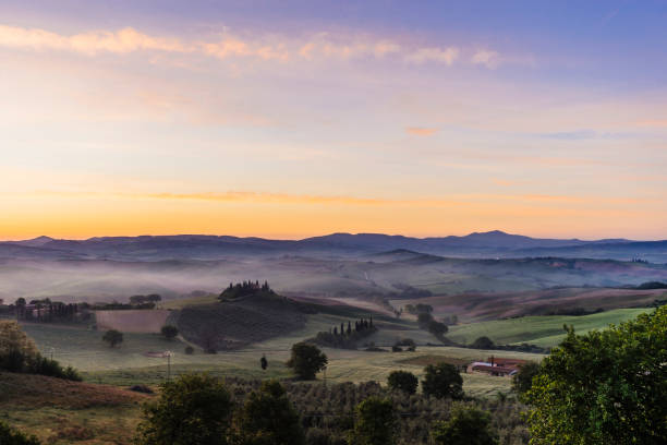 istock Tuscany landscape at sunrise with low fog 683060580