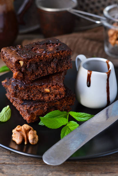 istock Homemade chocolate brownies with nuts, chocolate sauce and mint 683067434