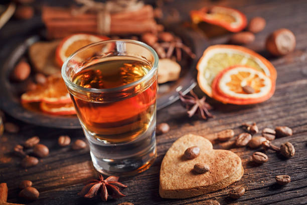 istock Whiskey or liqueur, cookies, spices and decorations on wooden background. 683070940