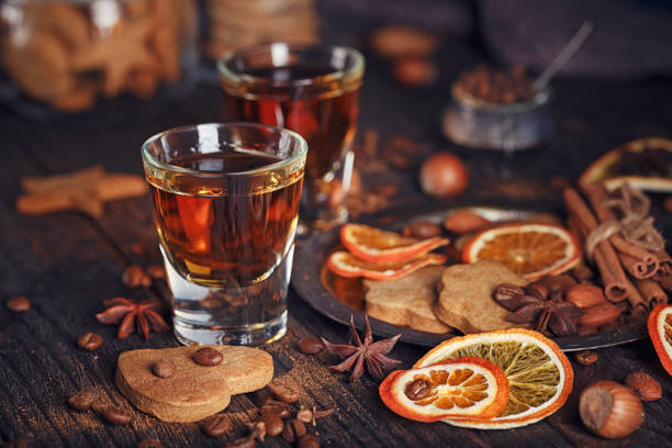 istock Whiskey or liqueur, cookies, spices and decorations on wooden background. 683070942