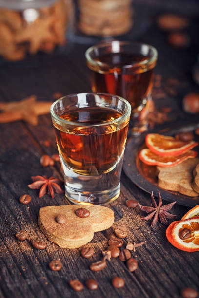 istock Whiskey or liqueur, cookies, spices and decorations on wooden background. 683070944