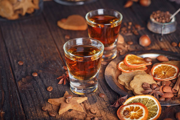 istock Whiskey or liqueur, cookies, spices and decorations on wooden background. 683070952