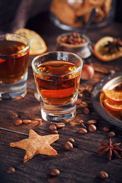 istock Whiskey or liqueur, cookies, spices and decorations on wooden background. 683070964