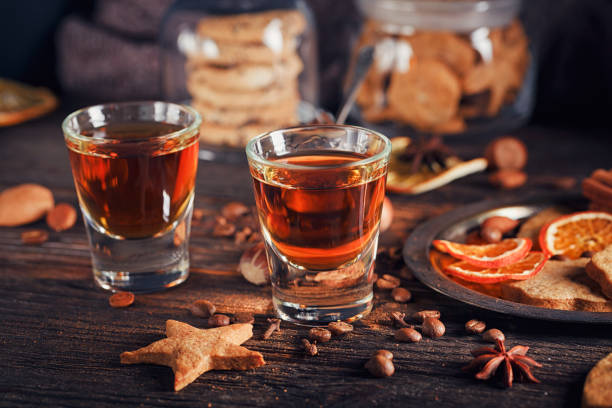 istock Whiskey or liqueur, cookies, spices and decorations on wooden background. 683070974