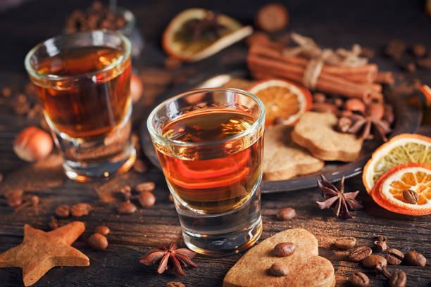 istock Whiskey or liqueur, cookies, spices and decorations on wooden background. 683070984