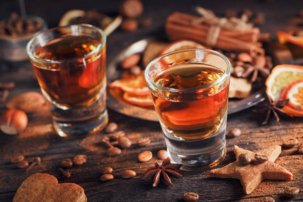 istock Whiskey or liqueur, cookies, spices and decorations on wooden background. 683070994